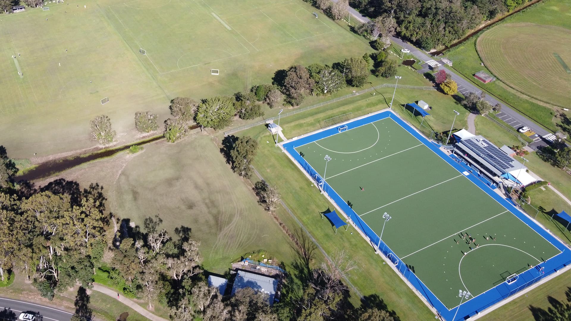 An aerial view of Ballinger Hockey Field with players gathered at one end of the field.