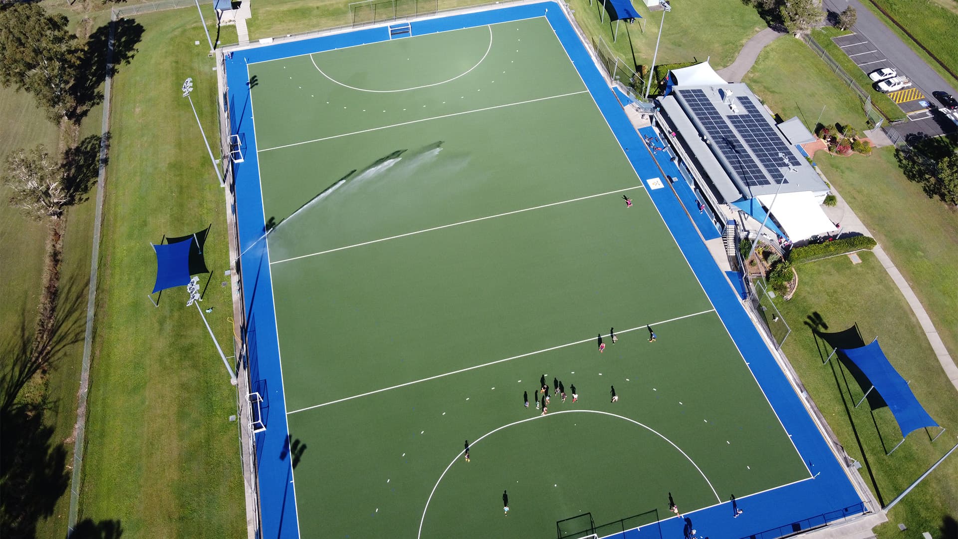 An aerial view of Ballinger Hockey Field with players gathered at one end of the field.
