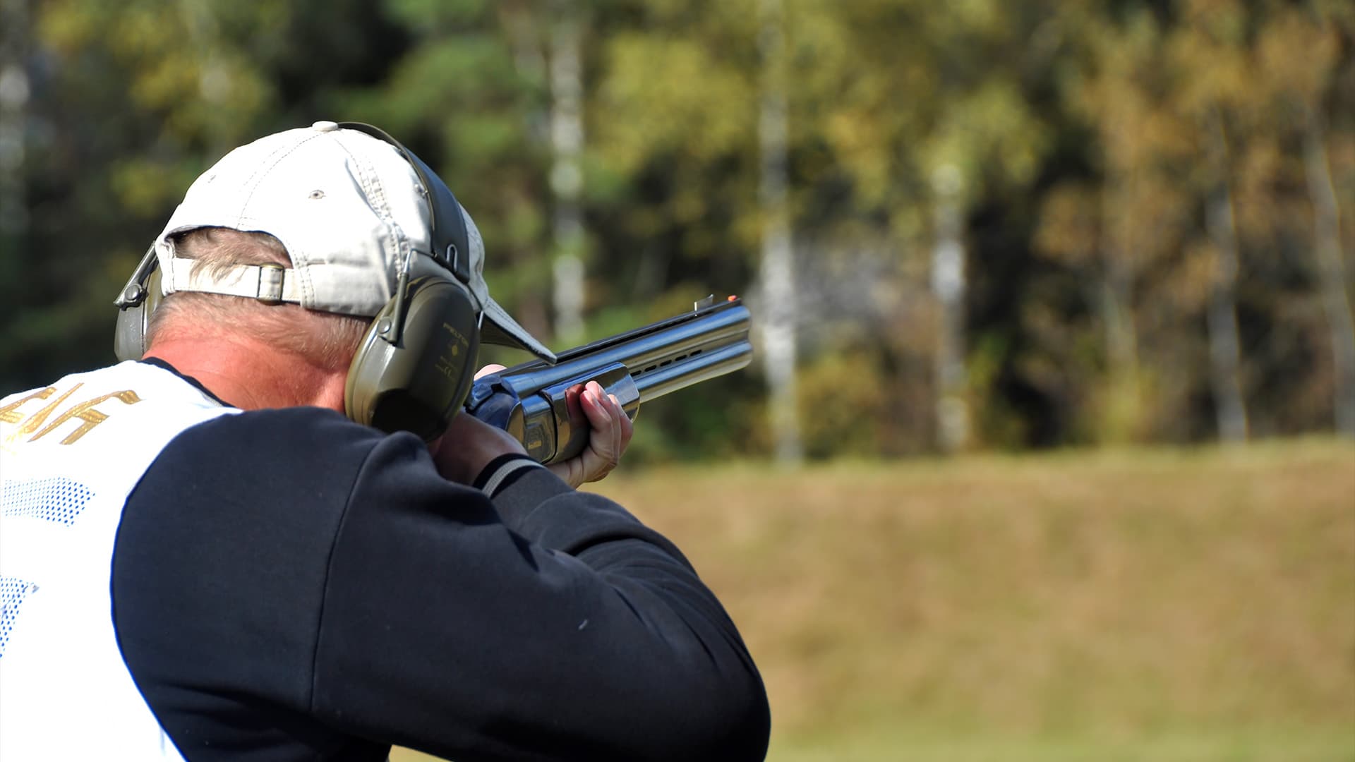 A close up view of a man shooting outdoors at Belmont Shooting Centre.