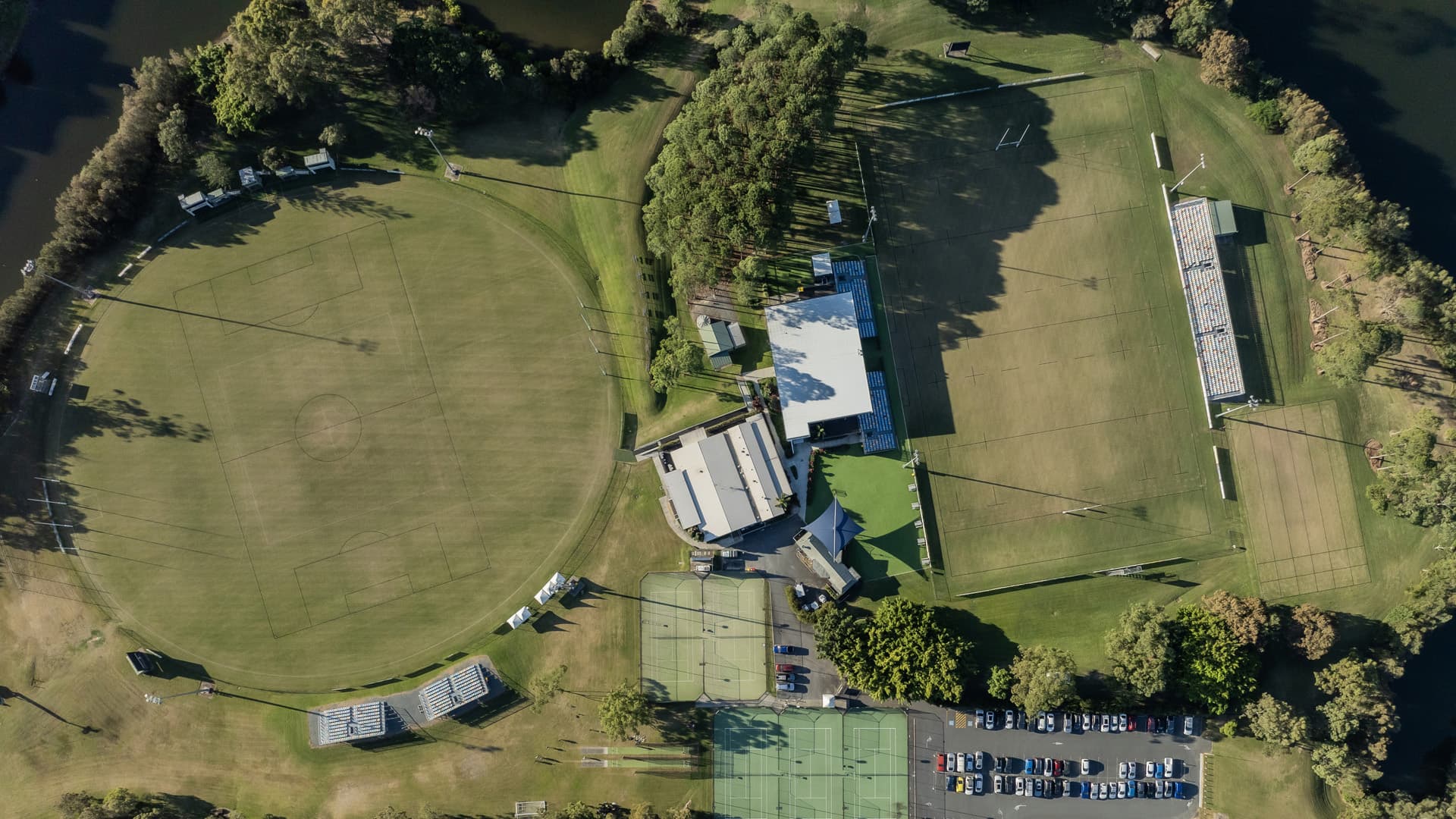 An aerial view of Bond University showing a rugby field, football field and tennis courts.