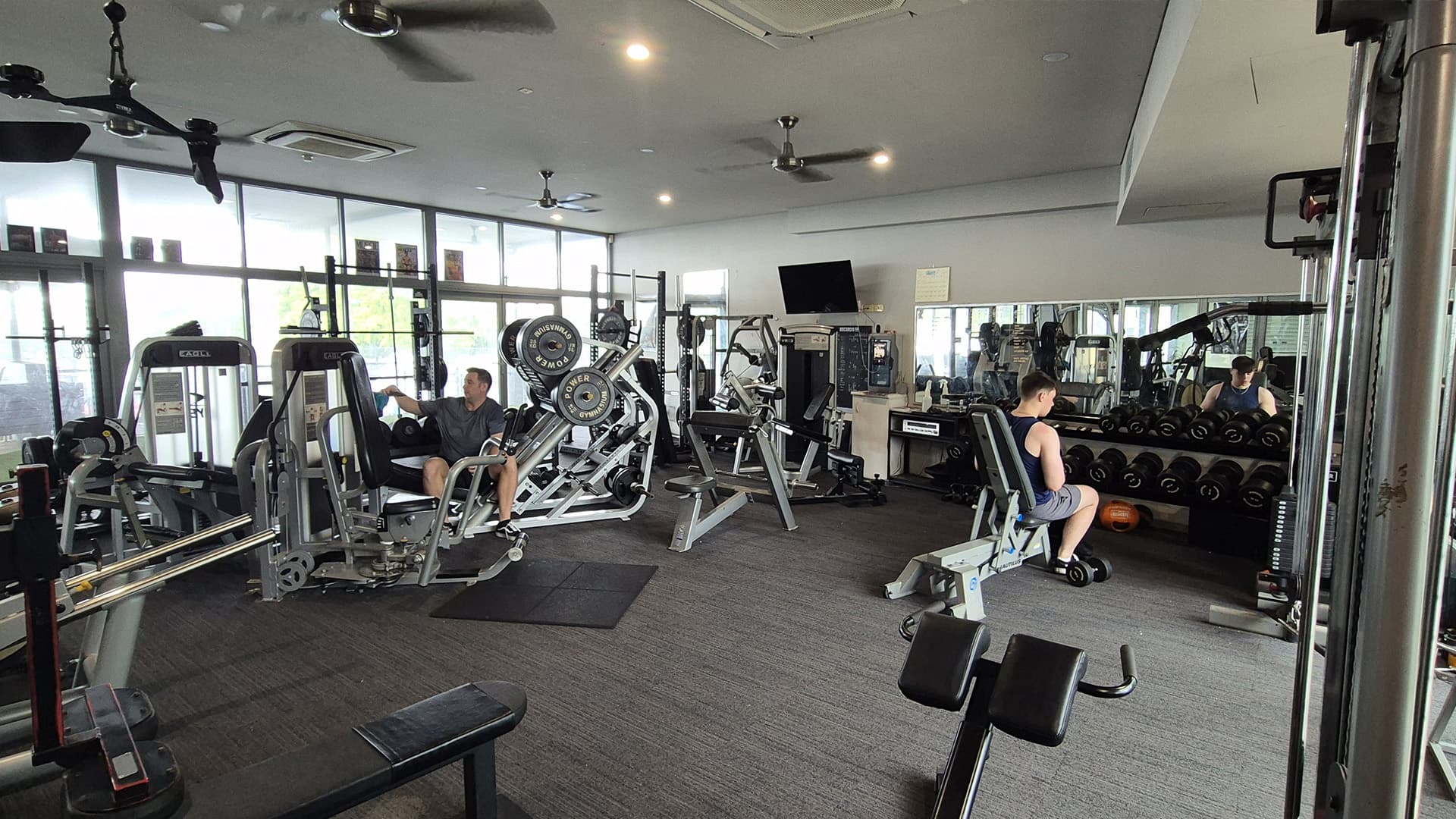 Cairns International Tennis Centre gym ammenities with two people using machines. 