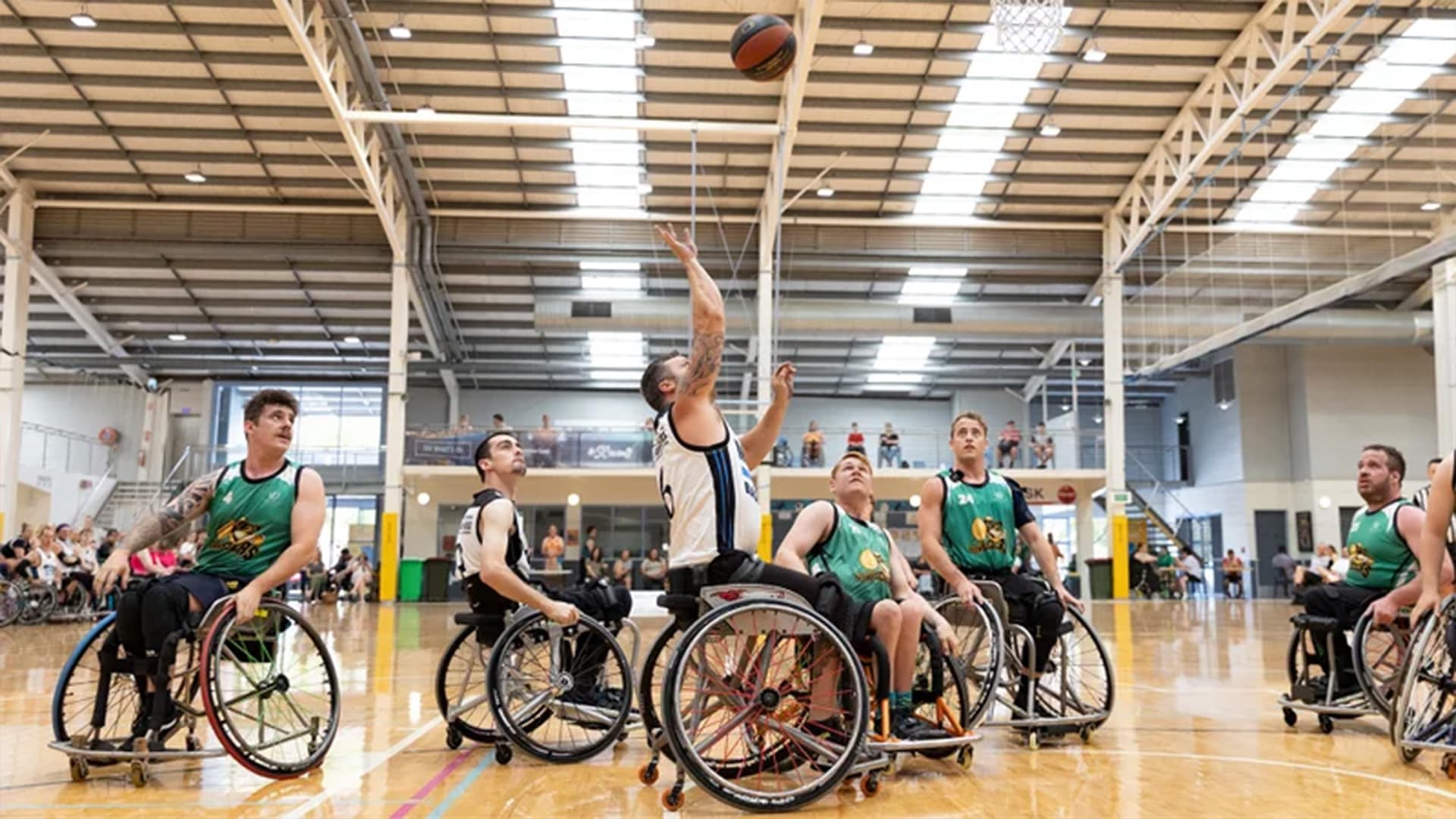 Parathletes playing wheelchair basketball at the Caloundra Indoor Stadium.