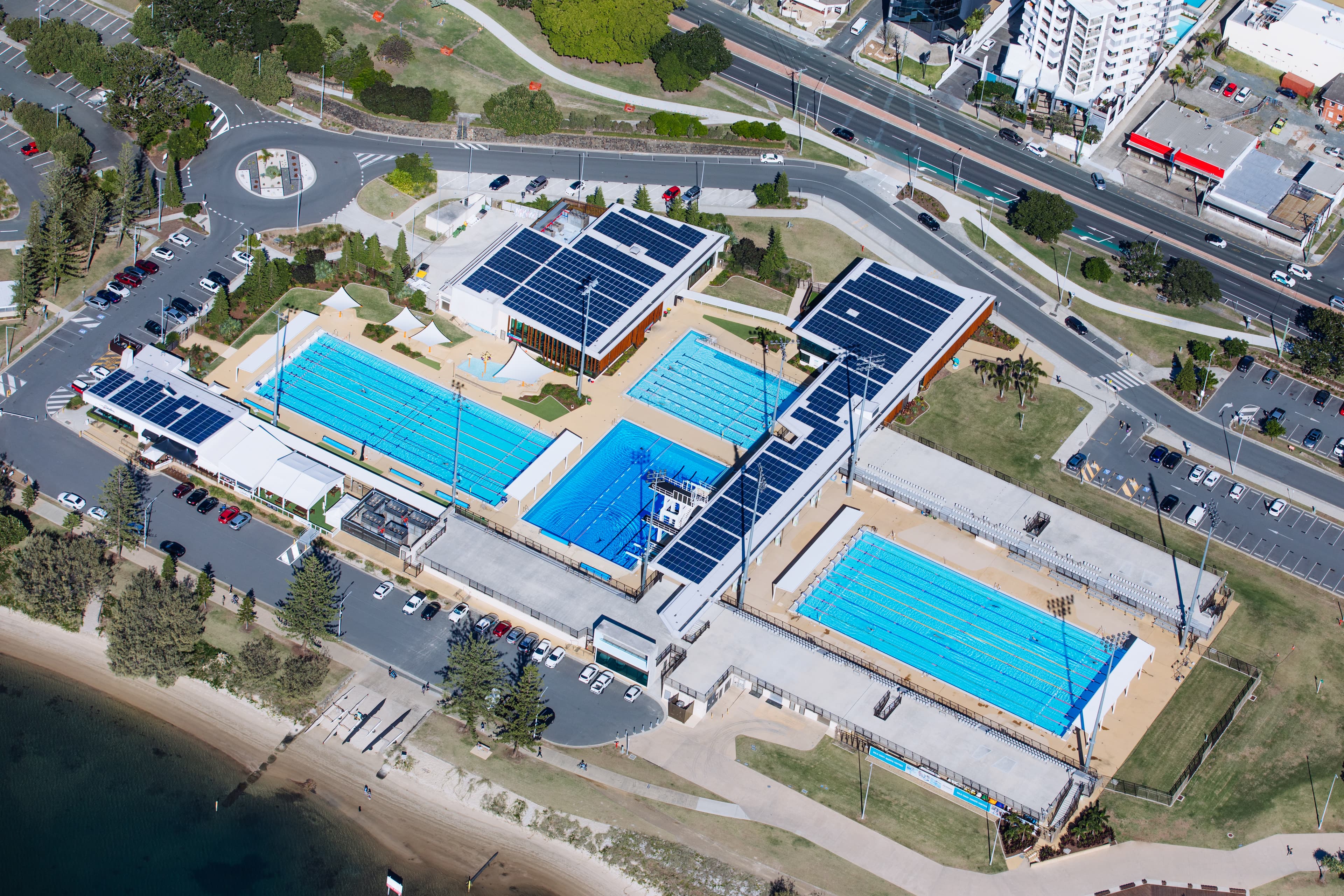 Aerial view of the Gold Coast Aquatic Centre showing 4 pools and supporting buildings