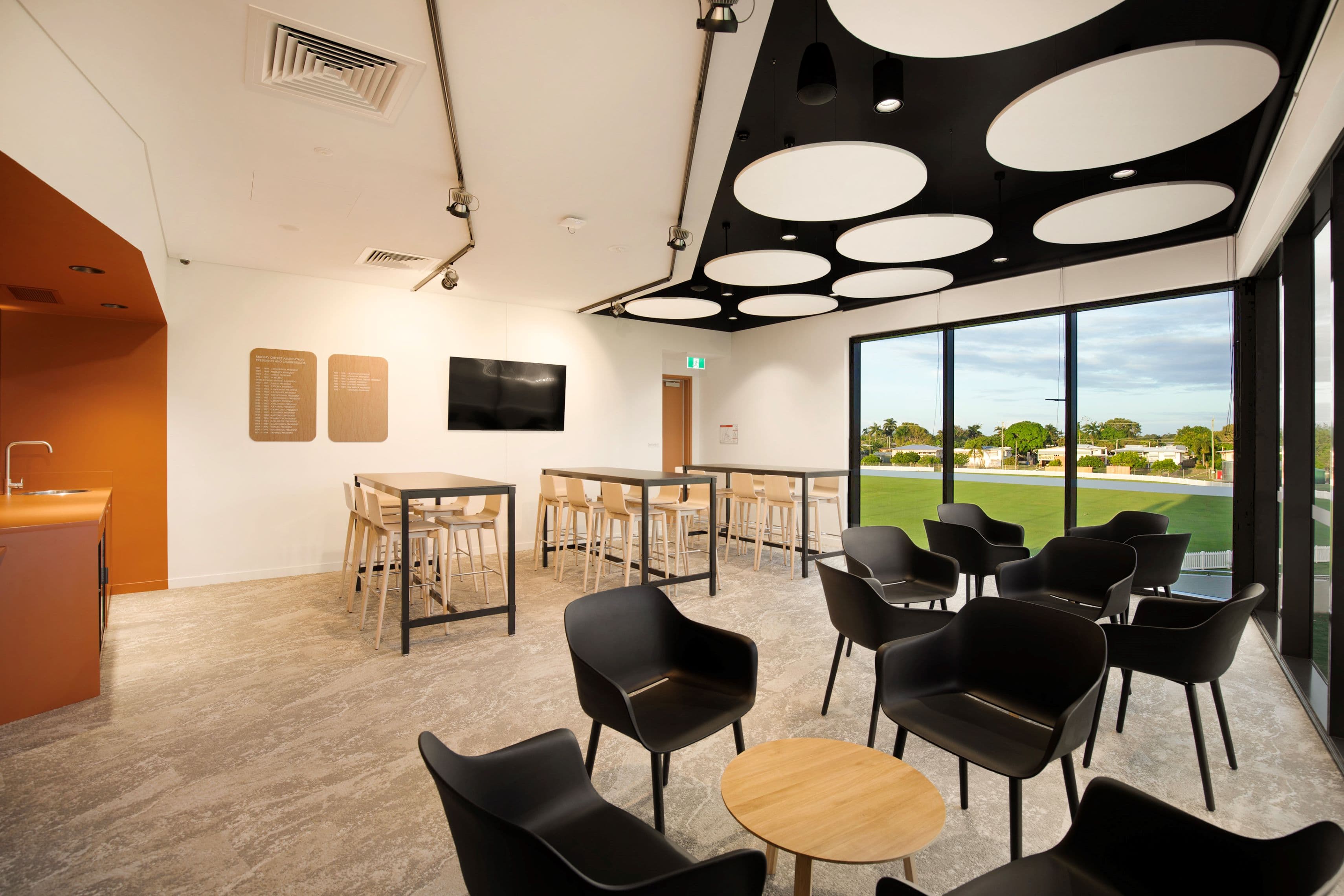 Table and chairs inside the Great Barrier Reef Arena Chairmans Room overlooking the oval