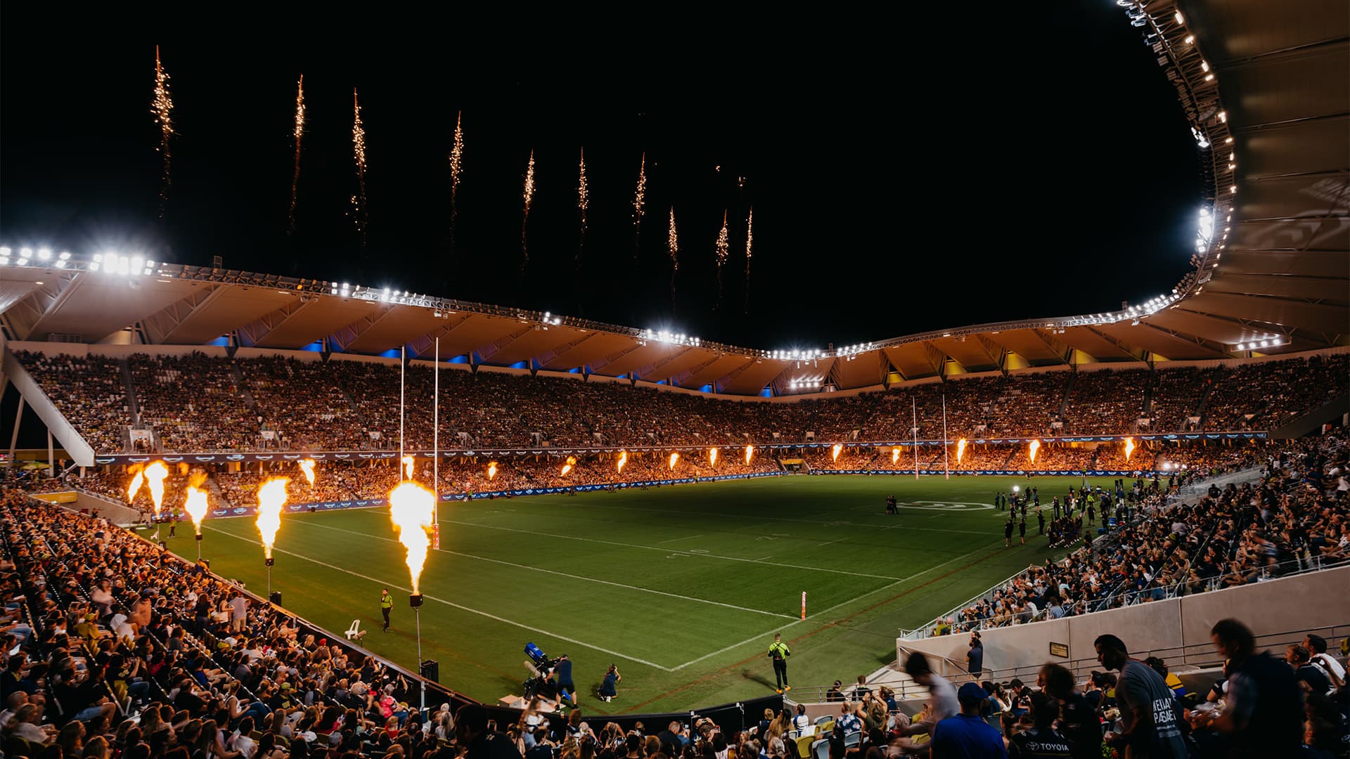 Full Queensland Country Bank Stadium during an evening game with the firework display.