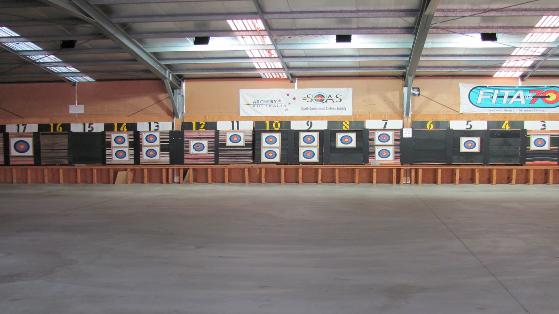 A wall of numbered targets in the indoor Samford Valley Target Archers society.