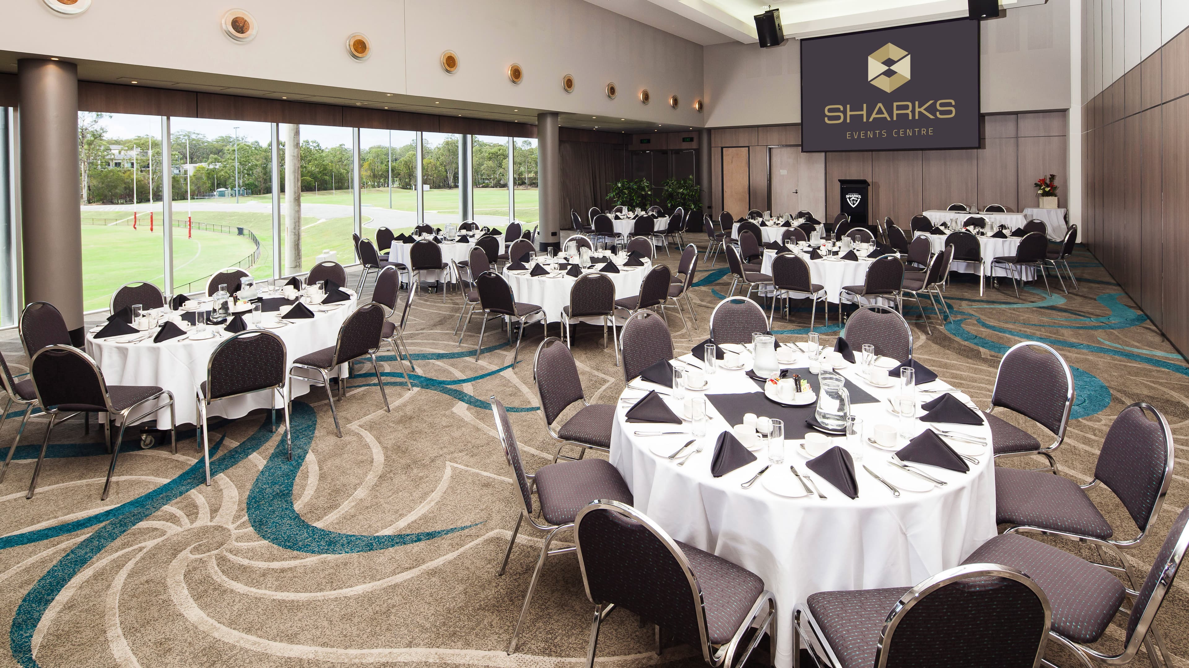 Round decorated tables inside a function room at Southport Sharks