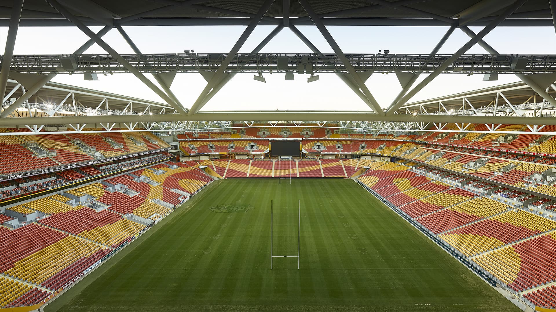 High overview of an empty Suncorp Stadium from behind the goal on a bright afternoon. 