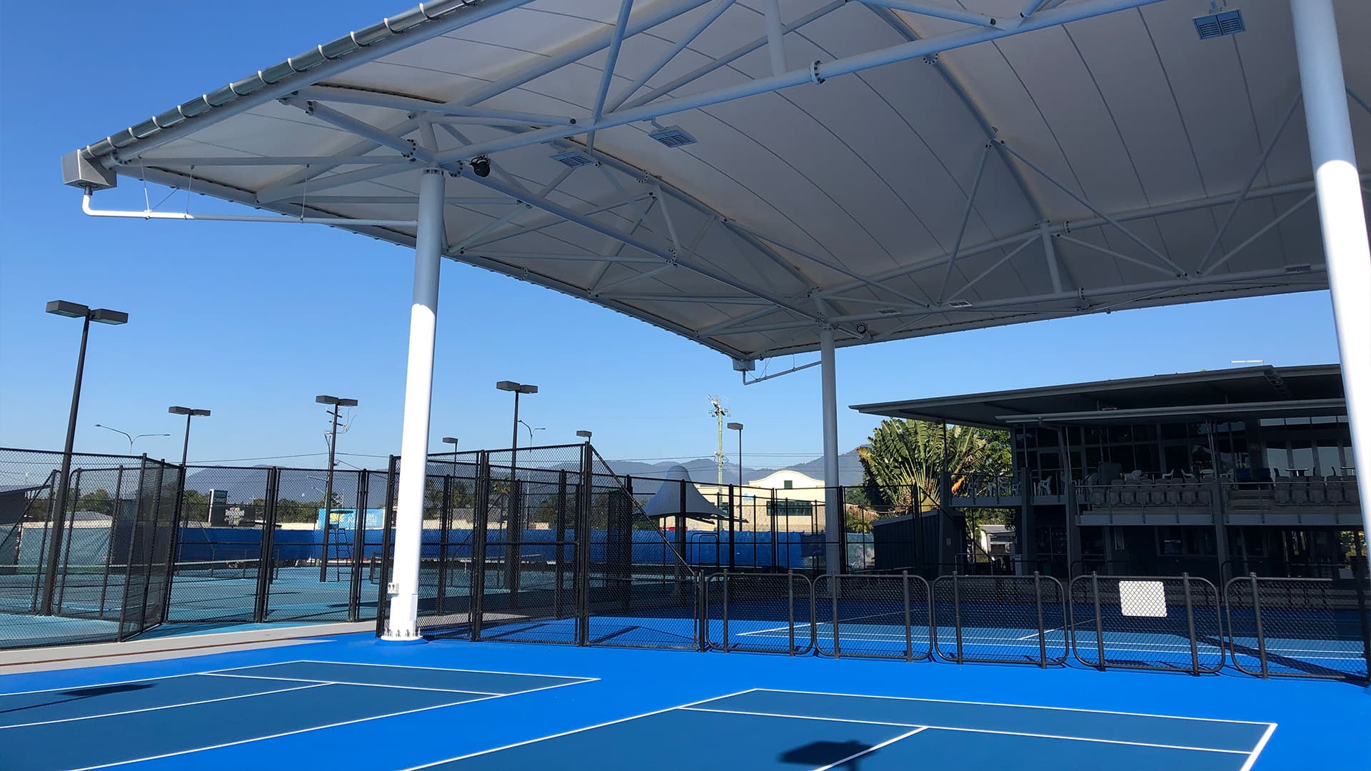 A wide angle view of the tennis courts at Cairns International Tennis Centre.