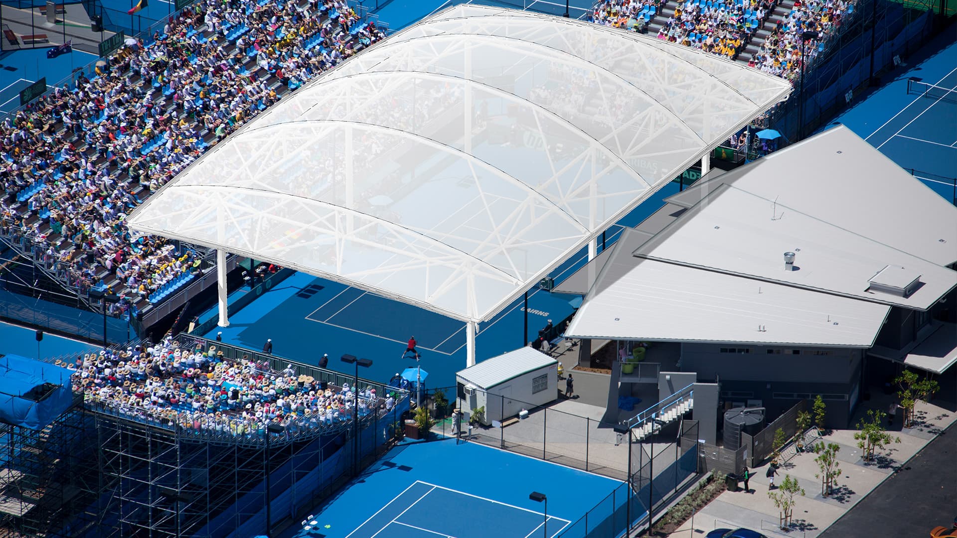 An aerial view of the Cairns International Tennis Centre with full spectator stands.