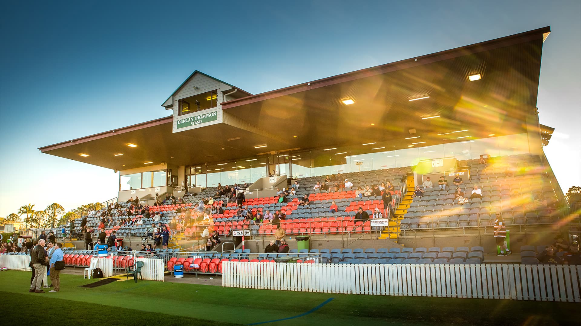 Toowoomba Sports Ground Field stands with people watching the game in the afternoon. 