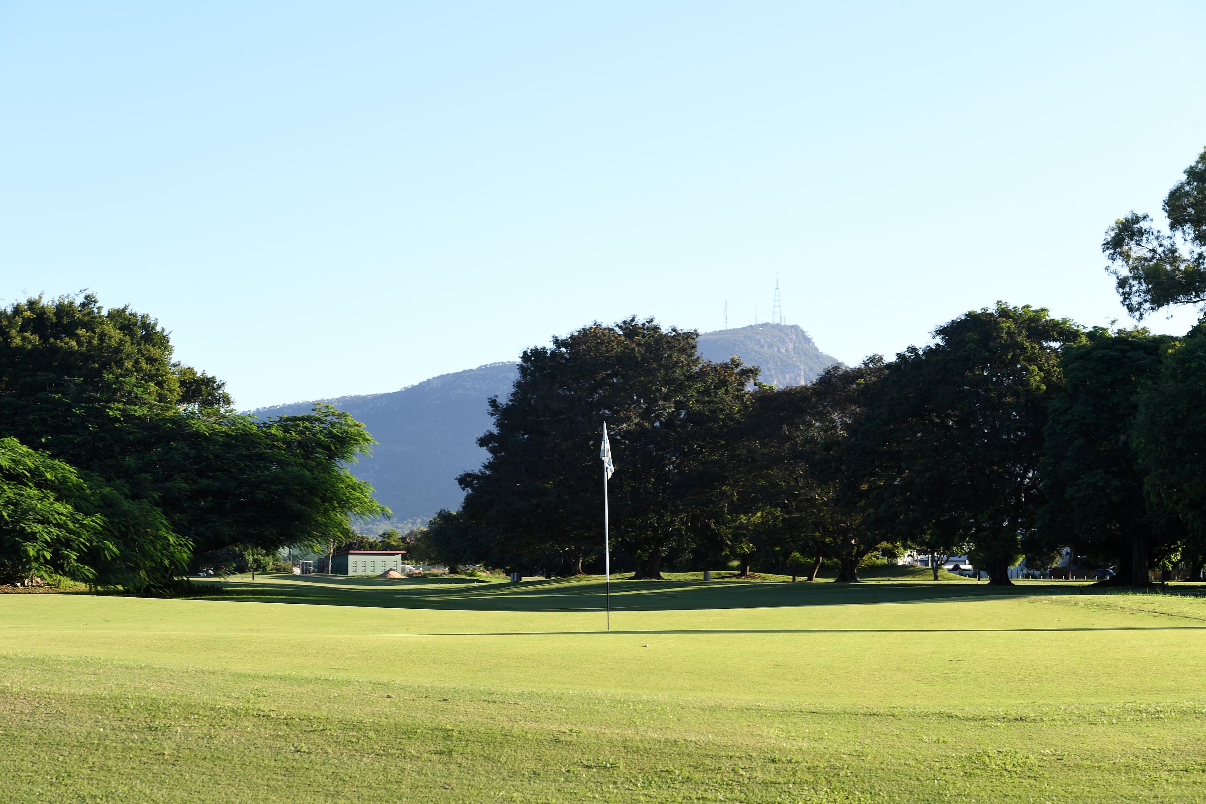 Manicured greens at Townsville Golf Club with mountains in the background