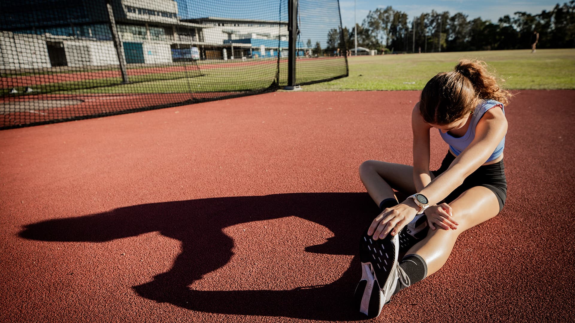 An athlete warming up on the UniSC athletics track